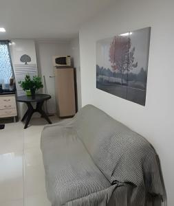 a living room with a couch in the corner of a room at otimo apart 2 quartos no recreio dos bandeirantes in Rio de Janeiro