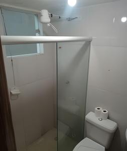 a white bathroom with a shower and a toilet at otimo apart 2 quartos no recreio dos bandeirantes in Rio de Janeiro +13 photos