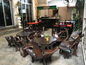 a group of tables and chairs in a restaurant at The Grand Palace Hotel in Bangkok