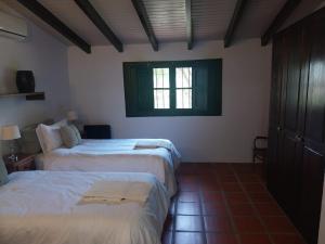 a bedroom with two beds and a window at Posada La Celia in Eugenio Bustos +95 photos