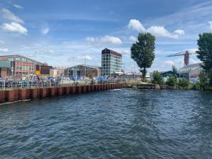 a body of water with a city in the background at Hotelschip Bracksand Amsterdam City, in de zomer én de winter! in Amsterdam