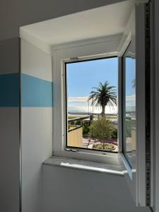 a bathroom window with a view of the beach at Your Sea Escape in Riva Trigoso