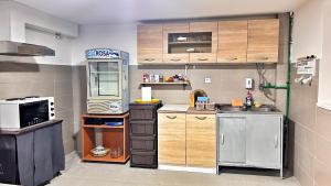 a small kitchen with a sink and a microwave at Emily's house in Čelarevo