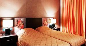 Postel nebo postele na pokoji v ubytování Hotel Cezaria
