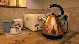 a tea kettle sitting on a counter next to a toaster at Palace View Apartment in Buxton