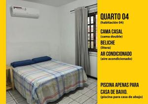 ein Schlafzimmer mit einem Bett und einem gelben Poster in der Unterkunft Soares Acomodações in Itapema