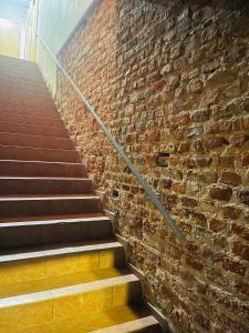 a brick wall with a staircase next to a brick building at IN ROOM Old town Kaunas in Kaunas +16 photos