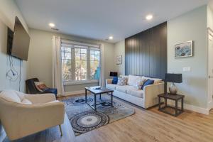 a living room with a couch and a tv at Walk to Shops on Front Street Traverse City Condo in Traverse City