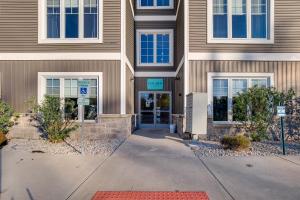 a building with a sign in front of it at Walk to Shops on Front Street Traverse City Condo in Traverse City