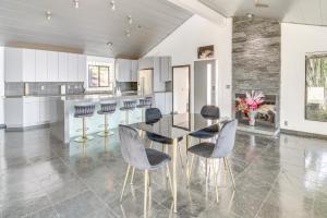 a dining room with a black table and chairs at Pool, Spa and Ocean Views - Modern Home in Malibu! in Malibu