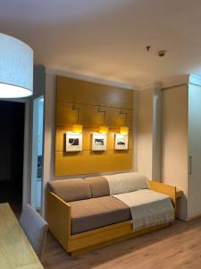 a bedroom with a bed with three pictures on the wall at Suitel Espetacular aeroporto Congonhas in Sao Paulo