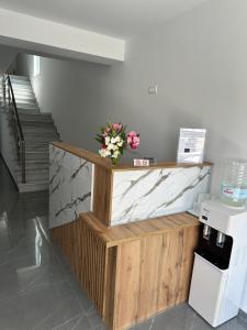 a vase of flowers sitting on top of a counter at ARA Luxury Suites in Polykhrono