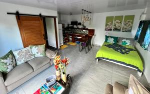 a living room with a couch and a bed at Miki Miki House in Fare