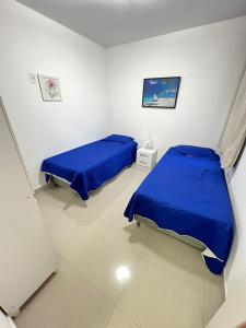 Ένα ή περισσότερα κρεβάτια σε δωμάτιο στο Quarto em Apartamento compartilhado Praia do Morro, Guarapari, Es - 20 m da Praia