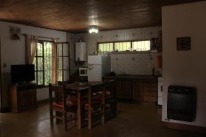 a kitchen with a table and chairs and a refrigerator at Uco Slow in Tunuyán