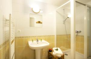 a white bathroom with a sink and a shower at Résidence Alexandre & Chartreuse - CHALET ALEXANDRE MAE-9571 in Vénosc +6 photos