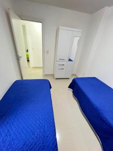 Ένα ή περισσότερα κρεβάτια σε δωμάτιο στο Quarto em Apartamento compartilhado Praia do Morro, Guarapari, Es - 20 m da Praia
