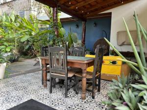 a wooden table and chairs on a patio at PRIVATE OASIS! New Casita with Parking, Garden and Outdoor Kitchen! in Lo de Marcos
