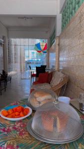 a living room with two plates of fruit on a table at Casarão historico in Recife