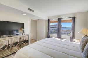 a bedroom with a large bed and a large television at El Matador 152 - FREE TICKETS!! Your stay includes free tickets to many area attractions! in Fort Walton Beach +36 photos