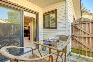 a patio with a table and chairs on a porch at Walk to Parks and Dining Quaint Alexandria Condo! in Alexandria