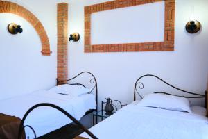 A bed or beds in a room at Janashia Boutique Hotels