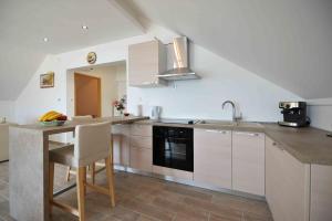 a kitchen with white cabinets and a sink and a counter at Apartment Mili in Betina