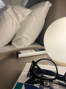 una mesa con lámpara y mando a distancia en VagaLuna Short Stay, en Catania