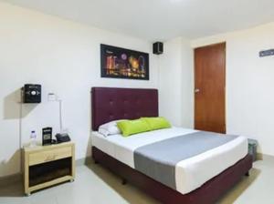 Postel nebo postele na pokoji v ubytování Hotel Colombia Avenida