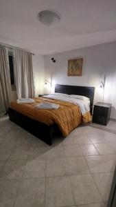 a bedroom with a large bed in a room at Casa a 7 minuti da aeroporto FCO vicino fiera di Roma!! in Fiumicino