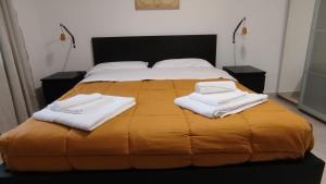 a bed with two white towels on top of it at Casa a 7 minuti da aeroporto FCO vicino fiera di Roma!! in Fiumicino +41 photos
