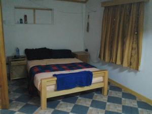a bedroom with a bed with a blue blanket on it at Proland Inn in Lokichokio