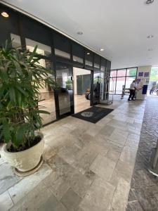 an empty lobby with a potted plant in a building at Ninety Stay Premium in Sao Paulo +61 photos