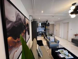 a living room with a couch and a table at Gem of Loxwood in Accra