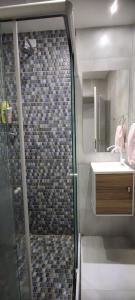 a bathroom with a shower and a sink at Casa Seridó - Caicó in Caicó