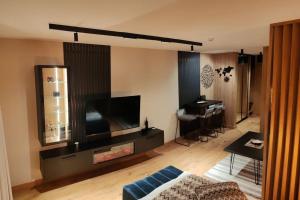 a living room with a large flat screen tv at Apartman D346 u sklopu Aparthotel Vučko in Jahorina