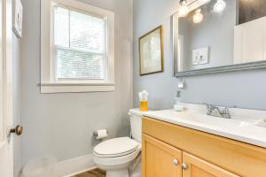 a bathroom with a toilet and a sink and a window at 1 Mi to Dtwn Wilmington Quiet Cottage with Deck in Wilmington +17 photos