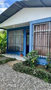 a blue building with a blue door and some plants at Blue House with Pool and Air-Conditioning in Puerto Jiménez