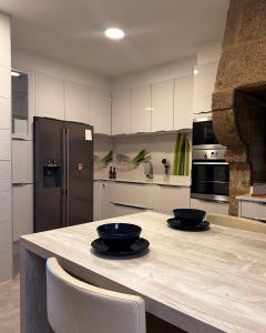a kitchen with a counter with two bowls on it at Apartamento Miracies in Vigo