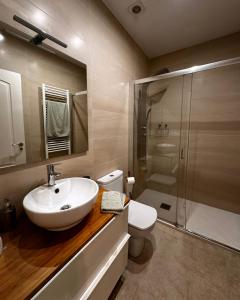 a bathroom with a sink and a toilet and a shower at Apartamento Miracies in Vigo +9 photos