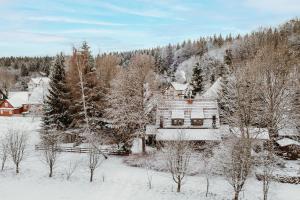 an old house is covered in snow at Harzchalet Brockenbahn 2B in Elend