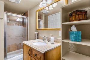 a bathroom with a sink and a mirror at Charming Country Club Condo with Loft & Fireplace in Flagstaff +17 photos