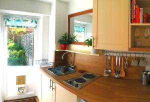 a kitchen counter with a sink and a window at Garden Studio in Marlow