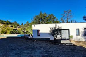 a white building with a tree in front of it at O Brésis d'Ales! in Alès
