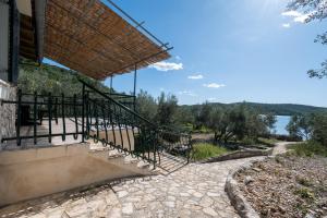 a staircase to a building with a view of the water at Secluded fisherman's cottage Cove Dragnjevica - Telascica, Dugi otok - 19966 in Sali