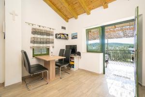 an office with a desk and chairs and a window at Secluded fisherman's cottage Cove Dragnjevica - Telascica, Dugi otok - 19966 in Sali