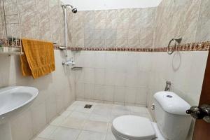 a bathroom with a toilet and a sink at Spacious 4-Bedroom Luxury Stay in the Heart of F10 in Islamabad +14 photos