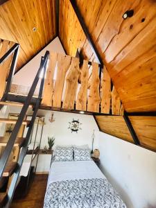 a bedroom with a bed in a room with wooden ceilings at Hotel en Huacas y Brasilito in Matapalo