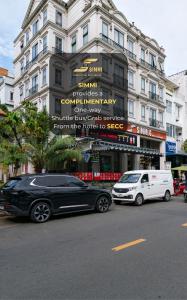 two cars parked on the street in front of a building at Simmi 6 Hotel & Apartment in Ho Chi Minh City