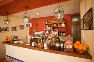 a bar in a restaurant with bottles of alcohol at Hostal Palomares in Salobreña